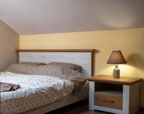a bedroom with a bed and a table with a lamp at Apartament Marrakech - City Center in Gabrovo