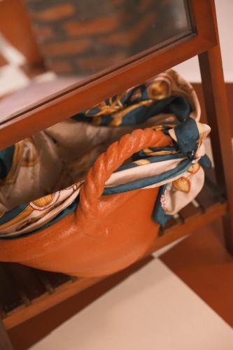 a bag with an orange rope on a shelf at Mekong Pottery Homestay, Green-Friendly & Boat Tour in Vĩnh Long
