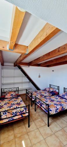 three beds in a room with a attic at Appartement plein centre-ville in Lodève