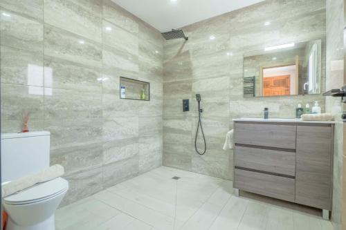 a bathroom with a shower and a toilet and a sink at Casa Angilaga in Jávea