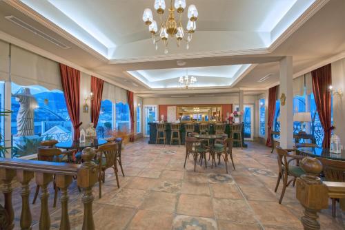 a dining room with tables and chairs and a chandelier at Antique Roman Palace Museum Hotel - Adults Only Ultra All Inclusive in Alanya