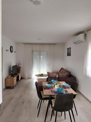 a living room with a table and a couch at Knežević apartman in Podgorica