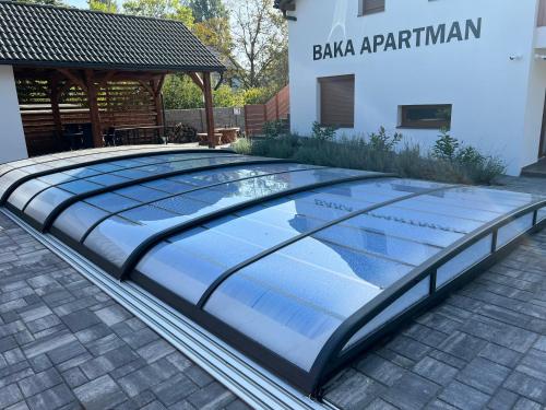 a large swimming pool in a courtyard of a building at Baka Apartman in Ábrahámhegy
