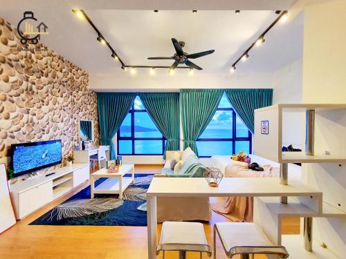 a living room with a couch and a tv at 1 min to Seaview & Sunrise Heart of Kuantan in Kuantan