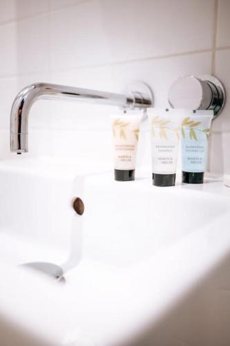 a bathroom sink with two bottles of moisturizers on it at Beach Bolthole 2 in Bournemouth
