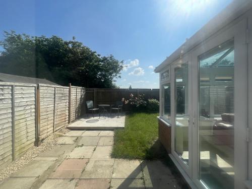 a backyard with a fence and a table and chairs at Fabulous Family Home in Lovely Little Stoke in Bristol