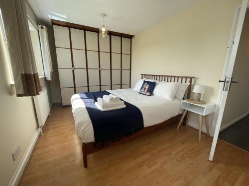 a bedroom with a large bed and a table at Fabulous Family Home in Lovely Little Stoke in Bristol