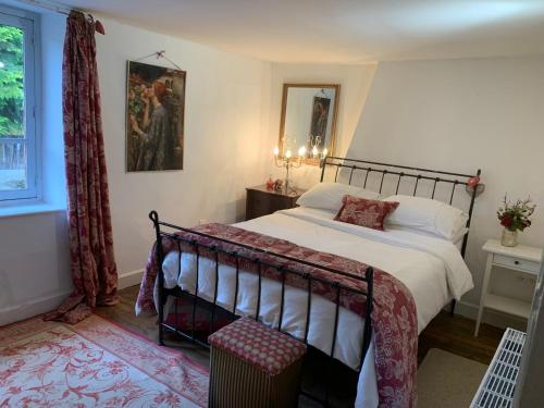 a bedroom with a large bed and a window at Lavande in Châtelus-le-Marcheix