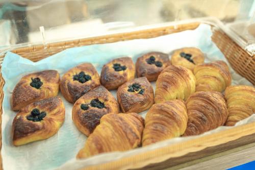 a tray of croissants and other pastries in a bakery at Aleenta Hua Hin - Pranburi - The Small Luxury Hotels of the World in Pran Buri