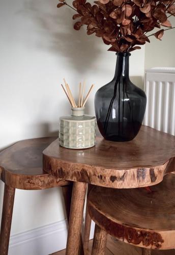 a wooden table with a vase on top of a table at Lochside Guest House in Arrochar