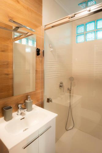 a bathroom with a white sink and a shower at El mirador de Mogro in Mogro