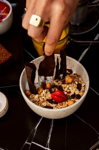 a person is reaching into a bowl of food at Boutique Hotel DARQ in Maastricht