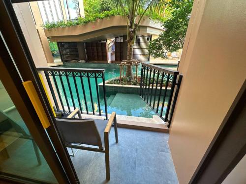 a view of a swimming pool from a balcony at The Proud Karon Beach Phuket Trademark Collection By Wyndham in Karon Beach