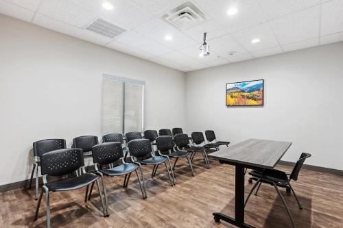 a room with a table and chairs in it at Candlewood Suites - Layton - Salt Lake City by IHG in Layton