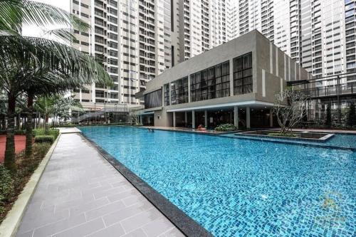 a large swimming pool in front of a building at Sky Residency in Nilai