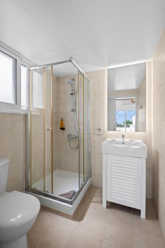 a bathroom with a shower and a toilet and a sink at Thalassines Villas in Ayia Napa