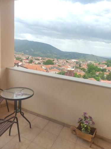 a balcony with a table and a view of a city at Hotel Siatistino Archontariki in Siatista