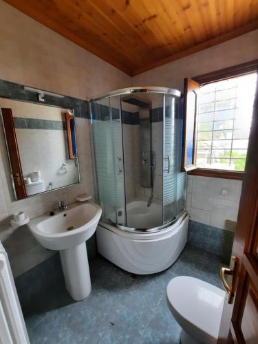 a bathroom with a shower and a sink and a toilet at Milea Byron House Tsagarada in Tsagarada