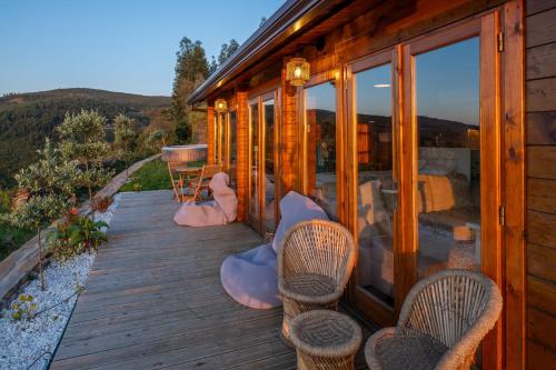 a wooden deck with chairs on a house at Wood House Amazing View Douro in Raiva