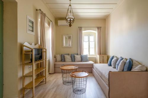 a living room with a couch and two tables at Teacher's House in Meganisi