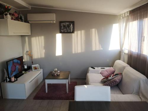 a living room with a white couch and a table at Veio Terrace in Rome
