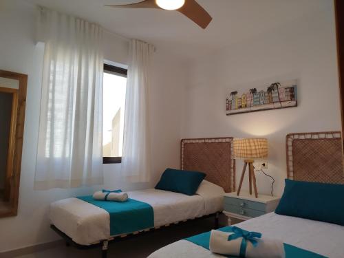 a bedroom with two beds and a window at Milion Destiny Entre Playas in Oropesa del Mar