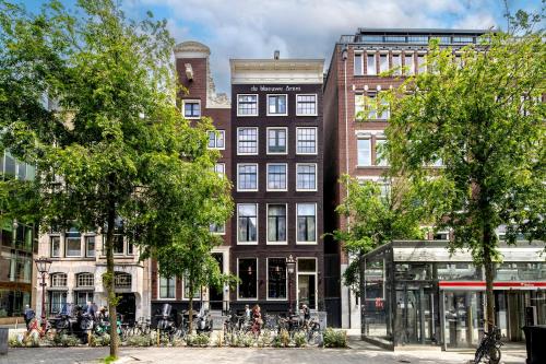a tall building with a clock tower on a city street at Mister Highland Hotel in Amsterdam