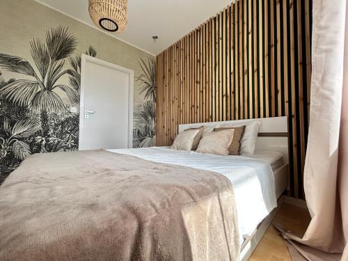 a bedroom with a large bed with a wooden wall at Colorado in Gdańsk