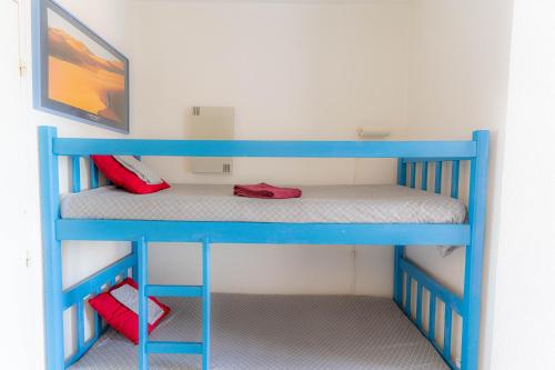 a blue bunk bed with red shoes in a room at Sanary Bandol plein SUD in Sanary-sur-Mer