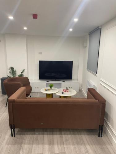 a living room with a couch and a tv at A Luxury High-End Studio in Birmingham