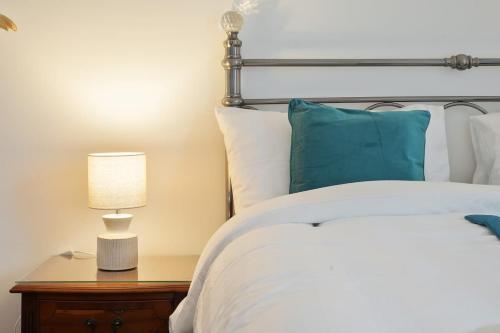 a bedroom with a bed and a lamp on a nightstand at Grimsby City Centre stay in Grimsby