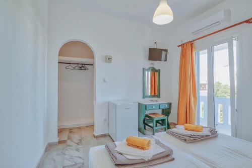 a white room with two beds and a window at Hotel Antiparos in Antiparos Town