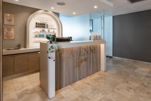 a store lobby with a counter with a sign on it at Pepperclub Hotel in Cape Town