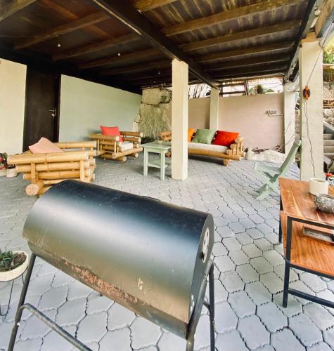 a patio with a couch and a table and chairs at Lakeside retreat and Golf in Bedugul in Bedugul