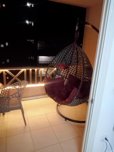 a hammock sitting on top of a balcony at شاليه ديمورا عائلات فقط Dimora Chalet Only Family in Dawwār Muḩammad Abū Shunaynah