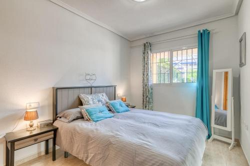 a bedroom with a large bed and a window at Lux de Novamar en Gran Alacant in Puerto Marino