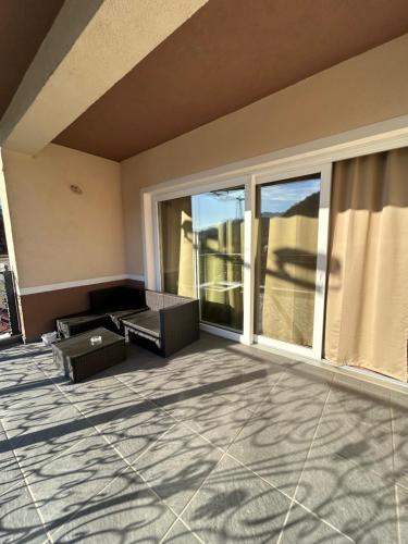 a living room with a large window and a couch at Apartmani prenj 1 i 2 centar in Konjic