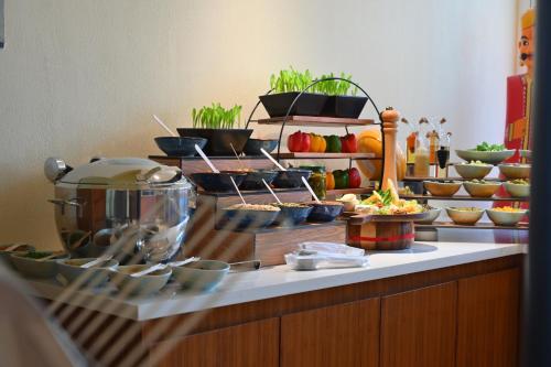 a buffet line with bowls and plates of food at The Park Visakhapatnam in Visakhapatnam