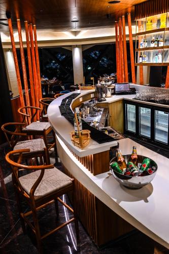 a bar in a restaurant with chairs and a counter at The Park Visakhapatnam in Visakhapatnam