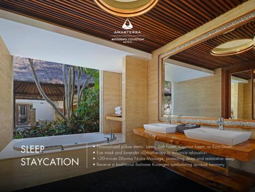 a bathroom with two sinks and a large mirror at Amarterra Villas Resort Bali Nusa Dua, Autograph Collection in Nusa Dua