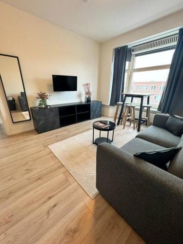 a living room with a couch and a table at Cosy Apartment in the Hague! in The Hague