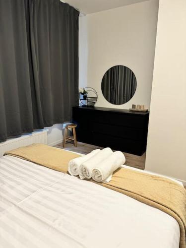 a bedroom with a bed with towels on it at Cosy Apartment in the Hague! in The Hague