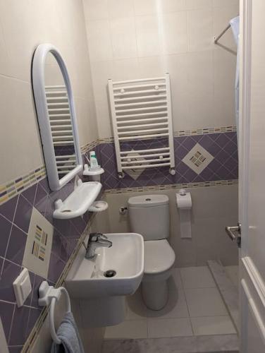 a bathroom with a toilet and a sink and a mirror at Dar soufia in Nabeul