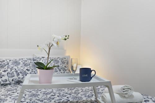 a coffee table with a plant and a mug on it at Aguaviva Perfect Holiday in Callao Salvaje