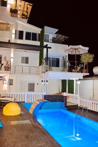 a large swimming pool in front of a building at Qeparo Napolon Complex in Qeparo
