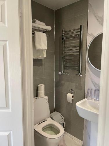 a small bathroom with a toilet and a sink at The Bell Inn in Evercreech