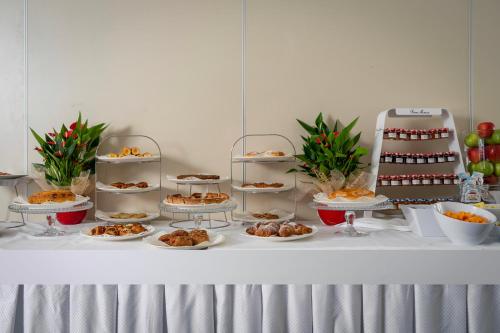 a table with several plates of food on it at Hotel Re Enzo in Bologna