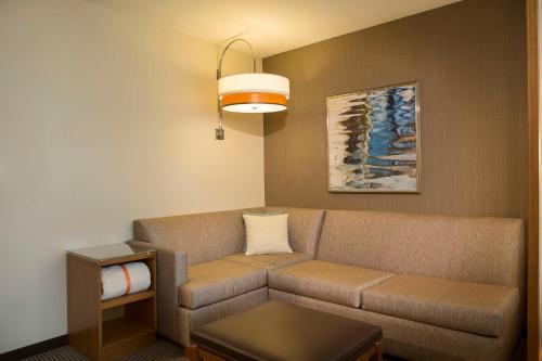 a living room with a couch and a table at Hyatt Place Washington DC/US Capitol in Washington