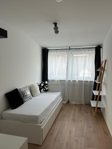 a white couch in a room with a window at Thê Rath Residence in Düsseldorf