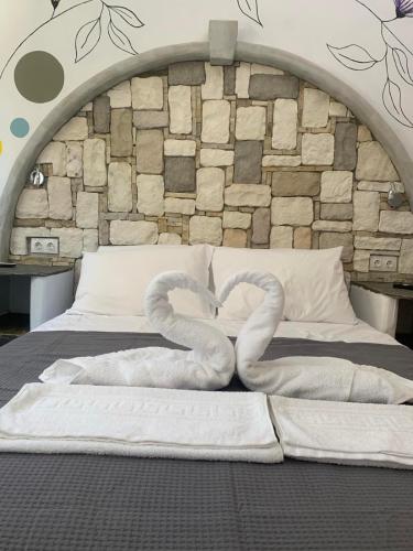 two swans made out of towels on a bed at Manello Home Art in Athens
